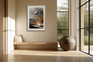 Light wood-framed autumn trees print above a built-in bench beside large grid windows.