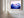 Close view of Violet Ranges mountain artwork with a wide white mat and light wood frame.