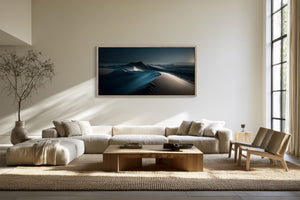 Light-framed dune artwork above a cream sectional sofa and wooden coffee table.