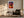 Light wood-framed sunset tree print above an armchair, side table, and floor lamp.