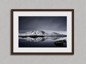 Silent Mirror shown in a walnut frame with a white border or mount.