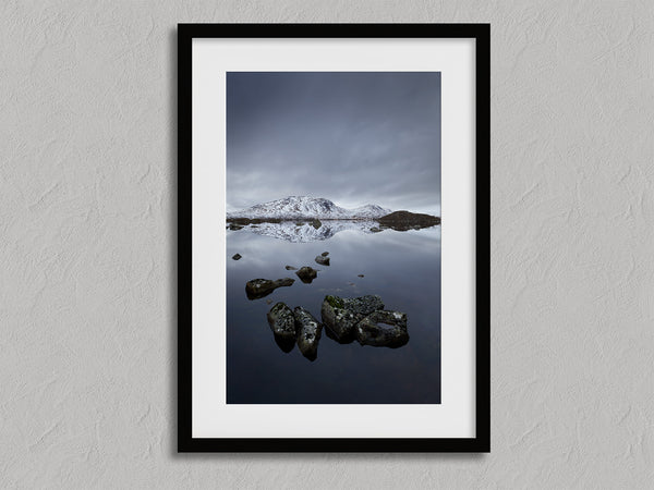 Quiet Reflections shown in a black frame with a white border or mount.