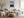 Light wood-framed mountain lake artwork above a cream sofa and wooden coffee table.