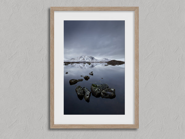 Quiet Reflections shown in an oak frame with a white border or mount.