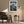 Framed mountain print above an armchair and side table with a floor lamp.