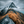 Snow-streaked mountain peak above a rocky ridge with ochre grasses and low cloud