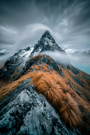 Snow-streaked mountain peak above a rocky ochre ridge, fine art print