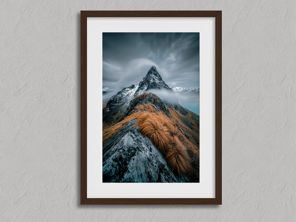 Cloudbound Peak shown in a walnut frame with a white border or mount.