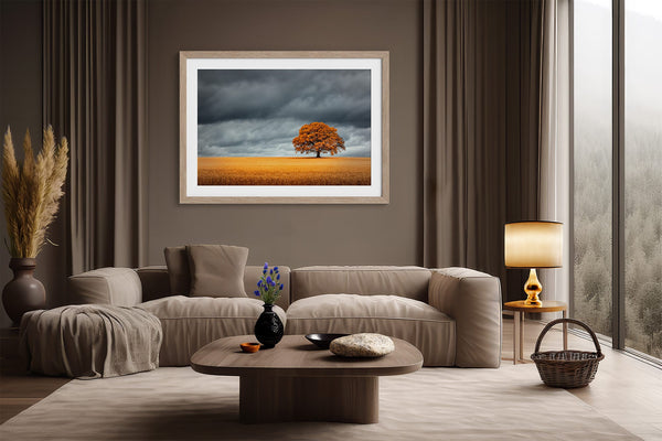 Framed oak landscape displayed above a cream sofa with dark curtains and floor lamp.
