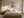Framed geometric hare artwork above a cream bed between two bedside tables.