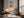 Framed geometric hare artwork above a leather lounge chair beside a sunlit window.