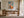 Framed geometric hare artwork above a wooden desk in a light-filled workspace.