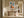 Framed geometric hare artwork above a rustic wooden console in a sunlit hall.