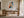 Framed geometric owl artwork above a wooden desk with chair and black task lamp.
