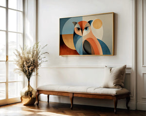 Framed geometric owl artwork above a cushioned wooden bench near tall windows and a vase of dried flowers.