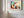 Close view of geometric owl artwork with white mat and wood frame on a paneled wall.