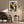Framed winter tree artwork above an armchair beside a floor lamp and small table.
