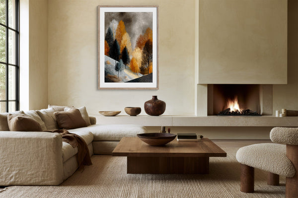 Framed winter tree artwork above a sofa and fireplace in a neutral living area.