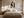 Framed winter tree artwork centered above a bed with matching bedside lamps.