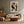 Framed winter tree artwork above a cream sofa with a wooden coffee table.
