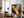Large black-framed winter tree artwork leaning beside an armchair and floor lamp.