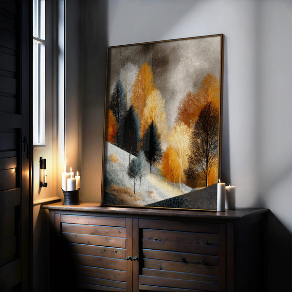 Close view of winter tree artwork in a thin dark frame above a wooden cabinet.