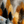 Stylised golden and dark trees on a snow-covered hillside beneath a textured grey sky