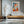 Light wood-framed geometric fox wall art above a low wooden console and chair.