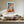 Light wood-framed geometric fox artwork above a cream sectional sofa and wooden coffee table.