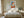 Light wood-framed geometric fox print centered above a bed with white bedding.