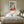 Light wood-framed geometric fox print centered above a bed with white bedding.