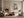 Framed orange fox geometric artwork displayed above a fireplace in a neutral living area.