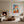 Framed orange fox geometric artwork displayed above a fireplace in a neutral living area.