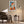 Framed geometric fox wall art above a dark armchair, side table, and floor lamp.
