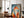 Large black-framed geometric fox artwork leaning beside a leather armchair and floor lamp.
