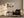 Light wood-framed geometric fox artwork above an armchair, side table, and black floor lamp.