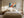 Light wood-framed orange fox artwork centered above a bed with matching bedside tables and lamps.