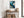 Framed teal and navy abstract artwork above a rustic console table with woven baskets.
