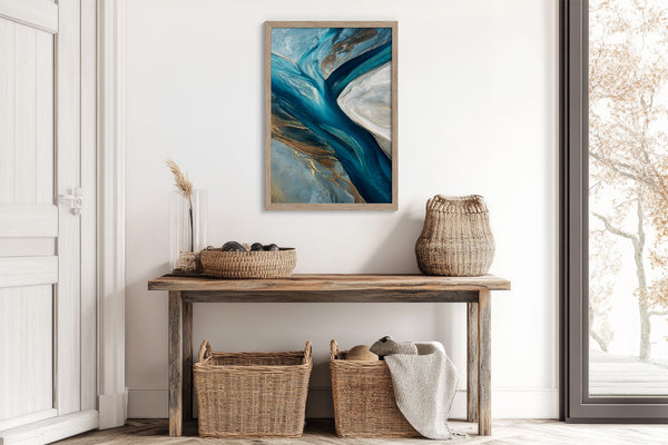 Framed teal and navy abstract artwork above a rustic console table with woven baskets.