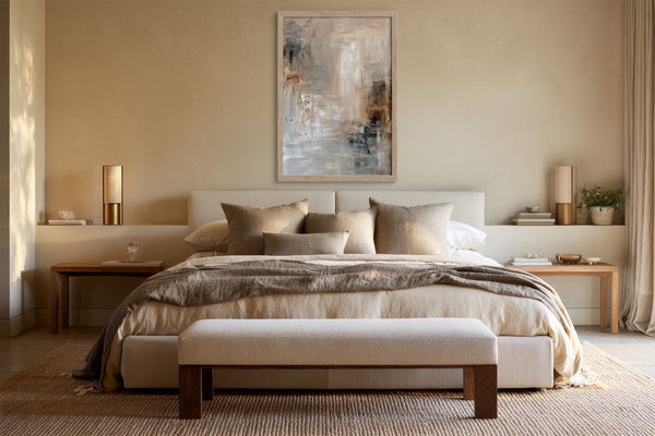 Quiet Layers II abstract wall art in a light frame above a bed with neutral bedding.