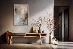 Light-framed abstract wall art above a wooden console with ceramic vases and branches.