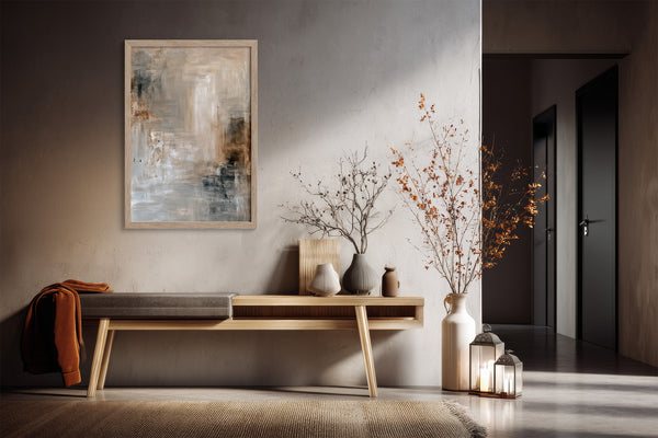 Light-framed abstract wall art above a wooden console with ceramic vases and branches.