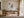 Quiet Layers II abstract print in a light frame above a wooden desk and chair.