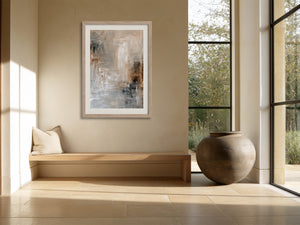 Framed beige and gray abstract artwork above a built-in bench beside tall windows.