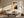 Copper Veil abstract wall art in a light wood frame above a cream sofa and wood sideboard.