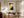 Framed Copper Veil abstract artwork displayed above a wooden desk beside tall curtained windows.