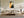 Copper Veil in a pale wood frame above a cream sectional and low wooden coffee table.