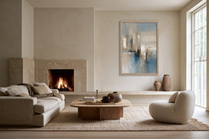 Blue Foundations I in a light wood frame above a fireplace in a neutral living area.