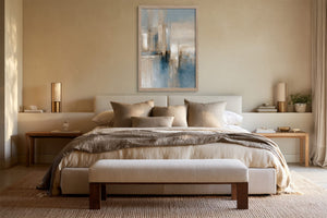 Blue Foundations I in a light wood frame centered above a bed with neutral bedding.
