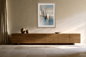 Blue Foundations I in a light wood frame above a low wooden sideboard.